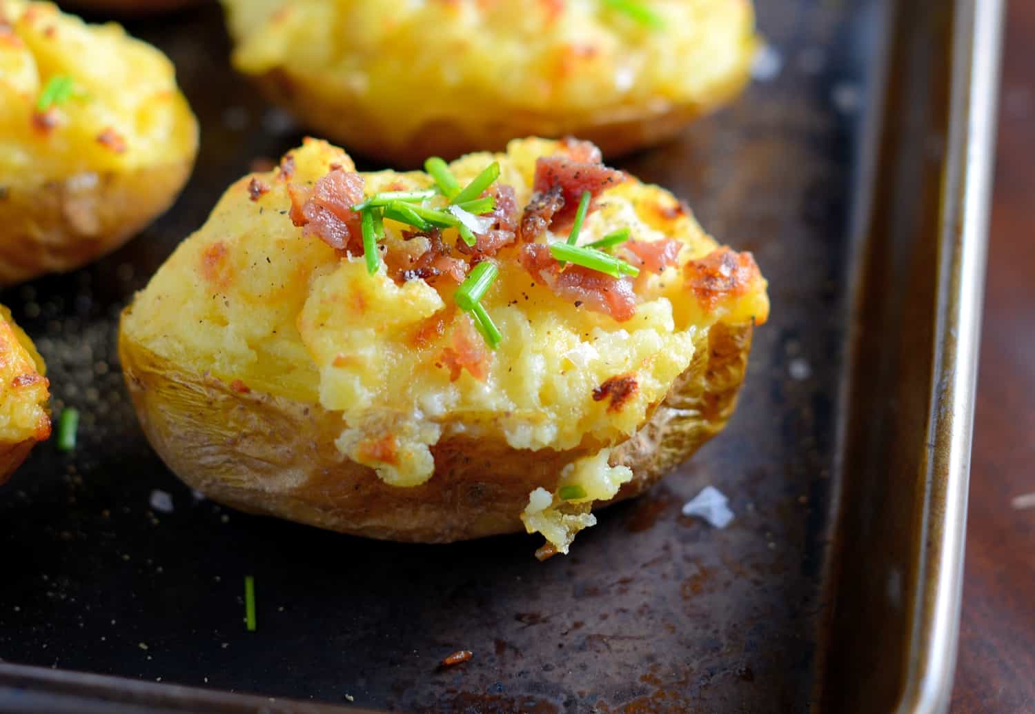 These cheesy twice baked potatoes are the BEST! My whole family gobbles them up, so I make double. The secret ingredient really makes these POP and stand out from the rest.