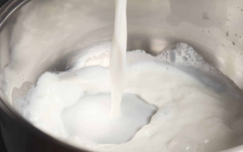 Milk being poured into a pan