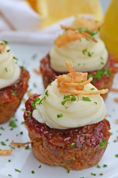 Three meatloaf muffins on a white plate