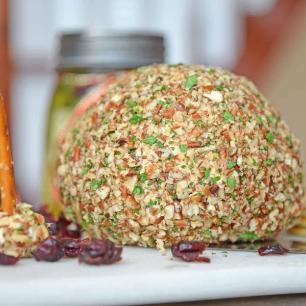 This cheese ball with cream cheese is a classic Party Cheese Ball recipe, made with simple ingredients. A must-make for any and all parties! #partycheeseballrecipe #creamcheeseball www.savoryexperiments.com