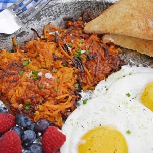 Sweet Potato Hash Browns are a simple breakfast recipe made with shredded sweet potatoes. Only 3 ingredients and a few minutes to cook! #sweetpotatohashbrowns #shreddedsweetpotatoes www.savoryexperiments.com