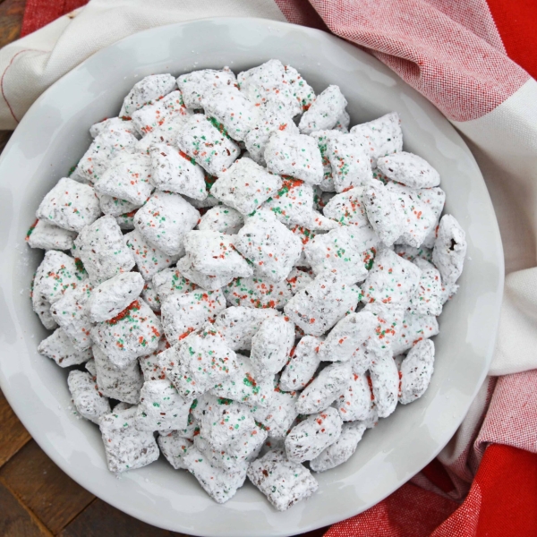 Christmas Puppy Chow transforms a traditional muddy buddy recipe into a festive Reindeer Chow mix! The perfect no-bake dessert for any party or event. #puppychow #reindeerchow #muddybuddy www.savoryexperiments.com