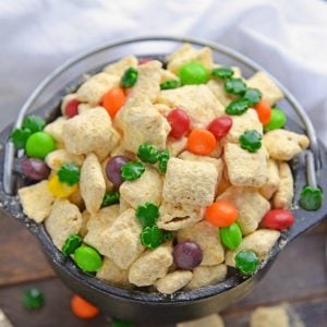 Pot of Gold PUppy Chow is the perfect gold St. Patrick's Day dessert or snack. Easy to make, make-ahead and delicious to eat, it will be the hit of your St. Patrick's Day bash! #puppychowrecipe #stpatricksday #potofgold www.savoryexperiments.com