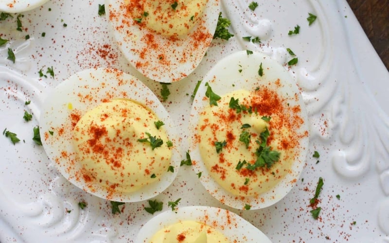 A close up of deviled eggs dusted with paprika