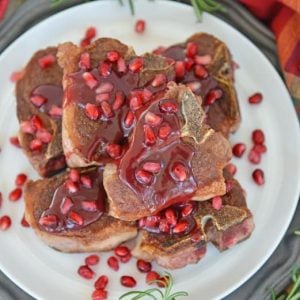 pomegranate lamb chops on a white platter