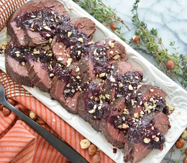 serving platter of beef tenderloin with blueberry sauce