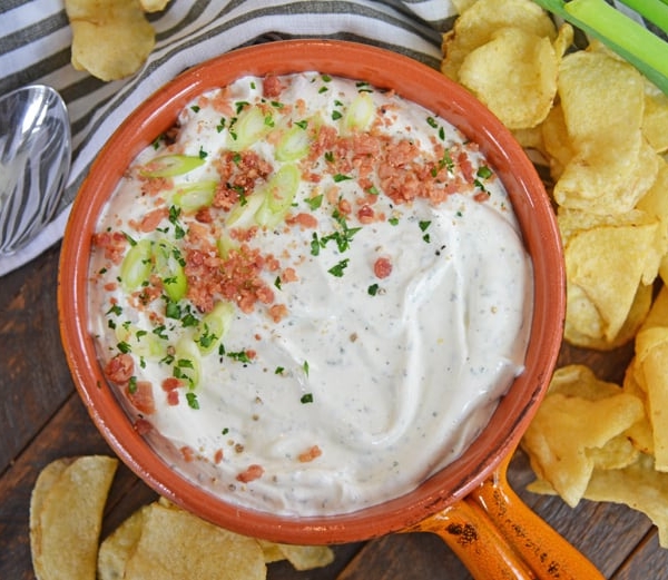 bowl of bacon ranch dip with scallions and potato chips