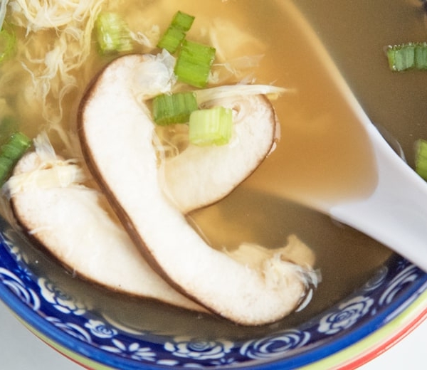 close up of sliced mushroom in soup