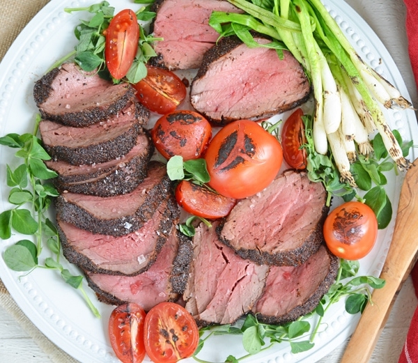 plate of seared beef tenderloin with tomatoes and scallions