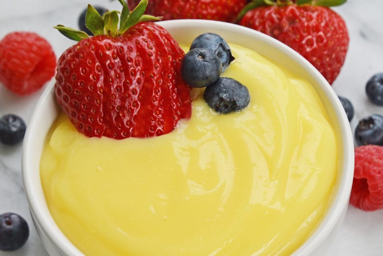 angle view of vanilla custard recipe with strawberry and blueberries