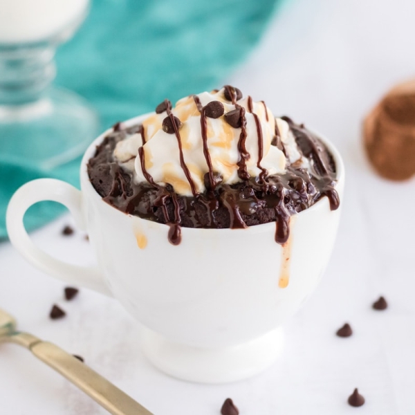 angle of brownie in a mug with teal background