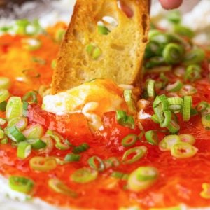 crostini dipping into goat cheese dip