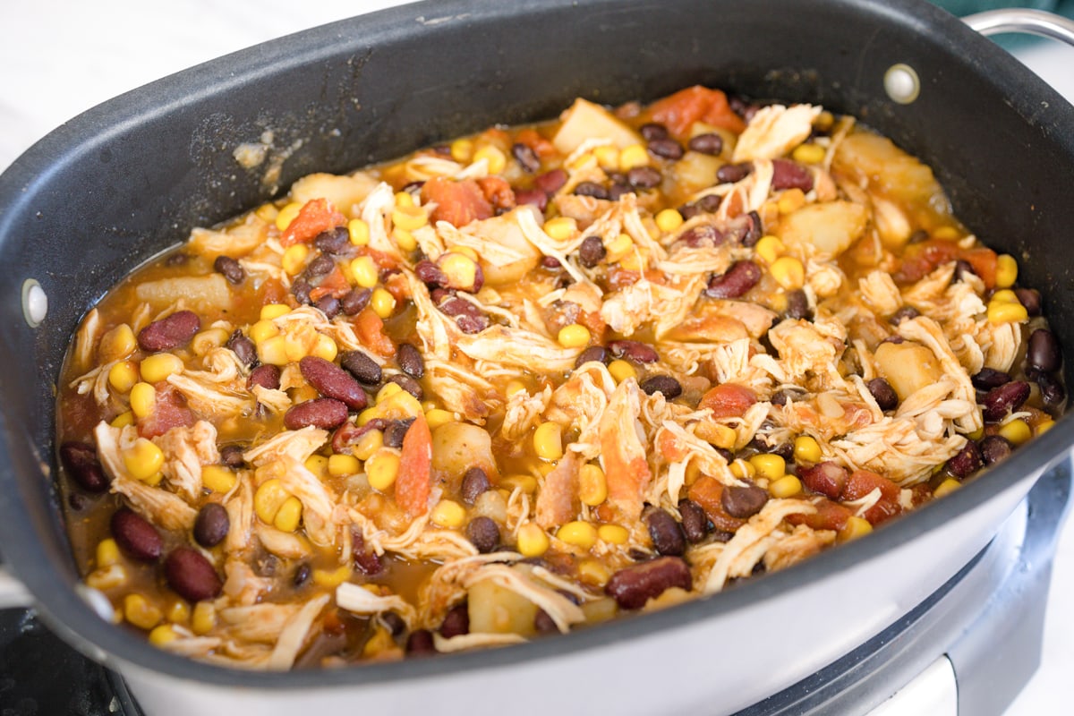 close up of chicken, corn and beans in a slow cooker 