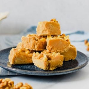 pile of maple walnut fudge on blue plate