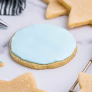 angled shot of rolled sugar cookie with blue icing