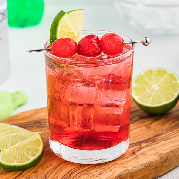 dirty shirley on a cutting board with limes