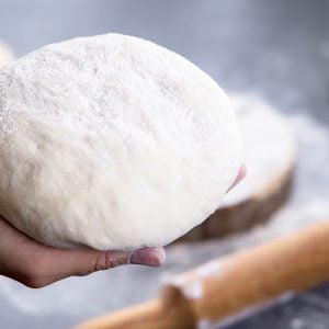 hand holding a dough ball