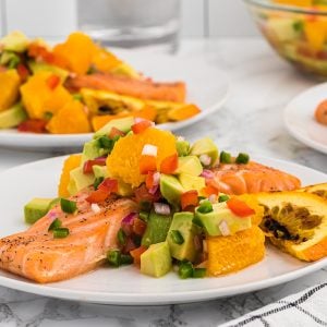 citrus salmon on a plate with orange slices