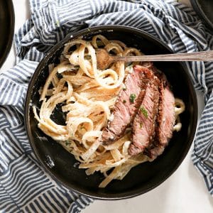 overhead of steak alfredo in a bowl