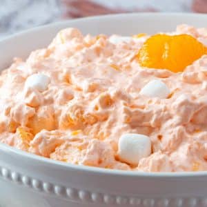 rim view of mandarin orange salad in a white bowl