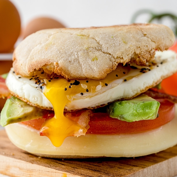 egg yolk dripping out of breakfast sandwich