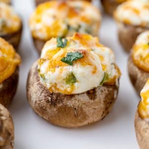 close up of cheesy stuffed mushrooms on a tray