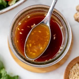 overhead shot of spoon in asian ginger salad dressing