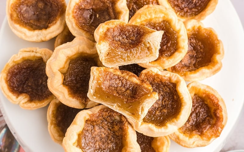 overhead shot of pile of butter tarts cut in half