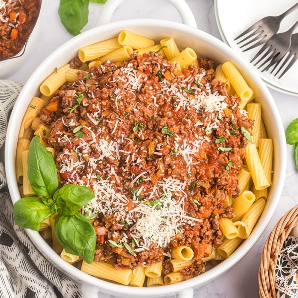 bowl of pasta topped with bolognese sauce