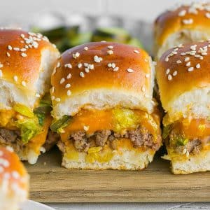 line of three big mac sliders on cutting board