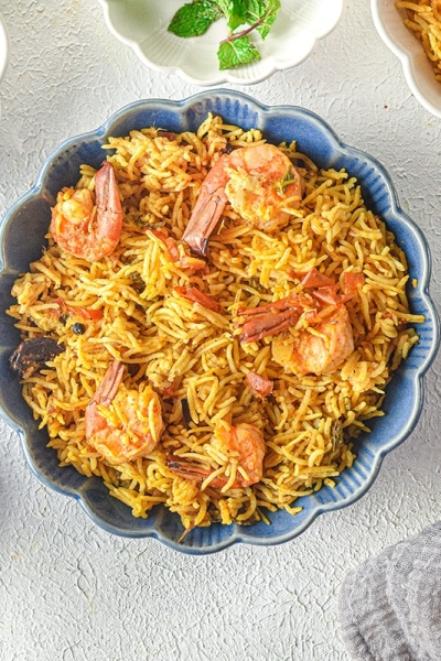 overhead of shrimp biryani in serving bowls