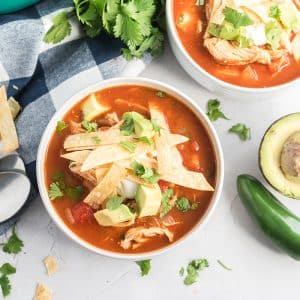 bowl of easy chicken tortilla soup with tortilla strips, avocado and cilantro