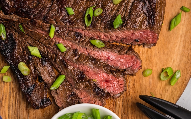 sliced skirt steak marinade on cutting board