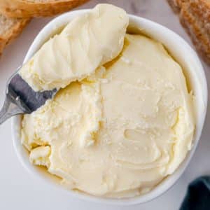 spreading knife in bowl of butter