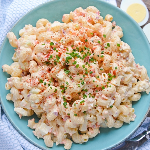 overhead of deviled egg pasta salad with chives and paprika