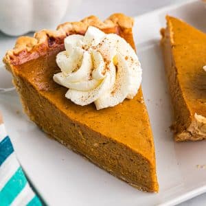 angled shot of slice of pumpkin pie