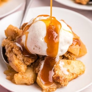 close up of caramel drizzled onto apple crisp