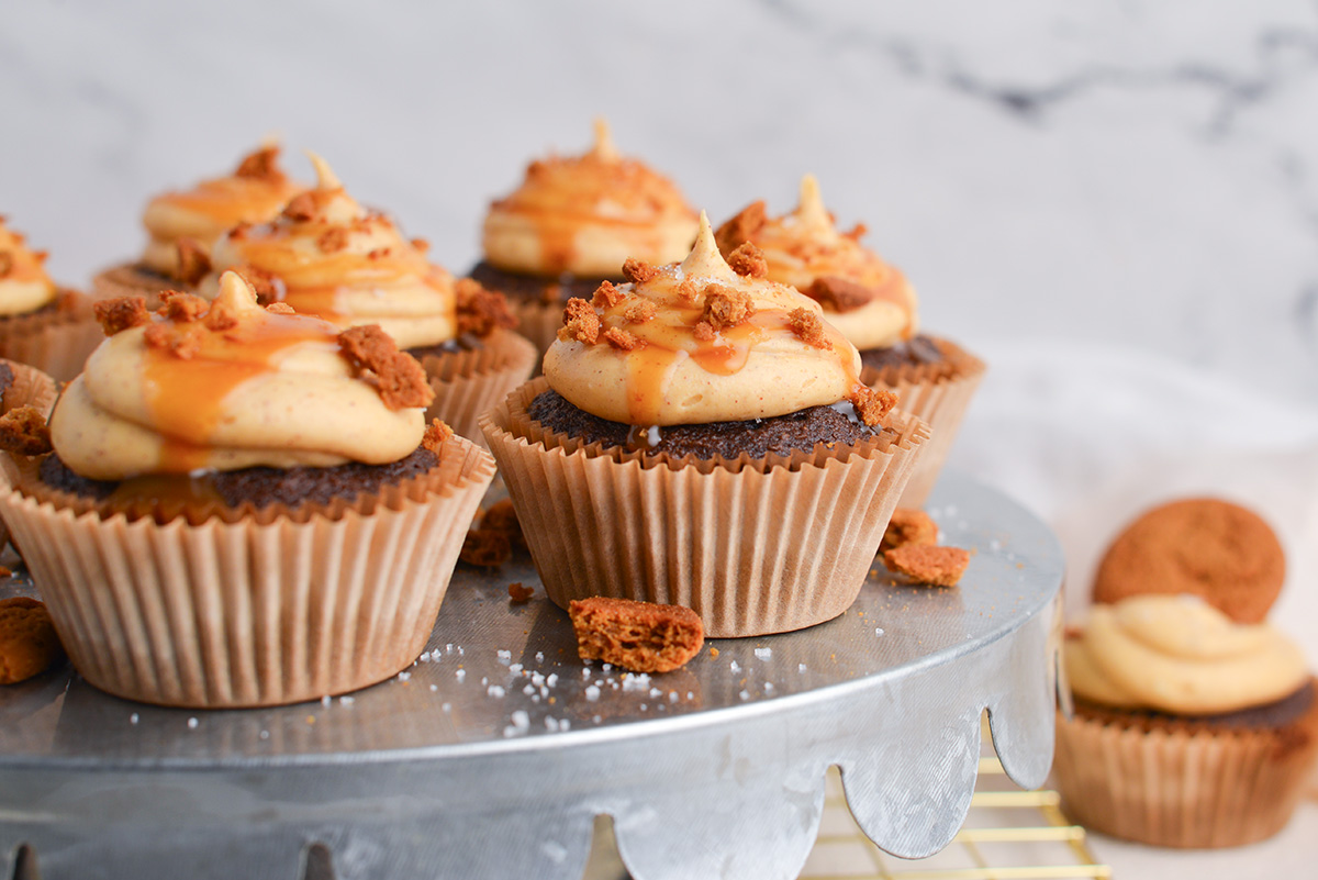 straight on shot of chocolate cupcakes on stand with pumpkin cream cheese frosting