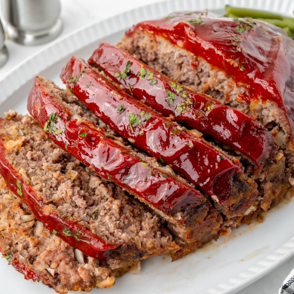 angled shot of sliced slow cooker meatloaf on a platter