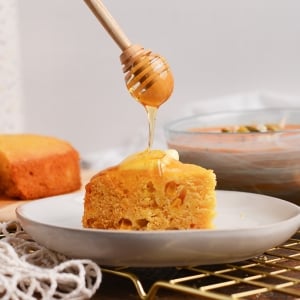 straight on shot of honey dripping onto cornbread