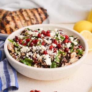 angled shot of wild rice salad in white bowl