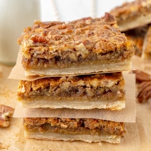 angled shot of stack of pecan pie bars