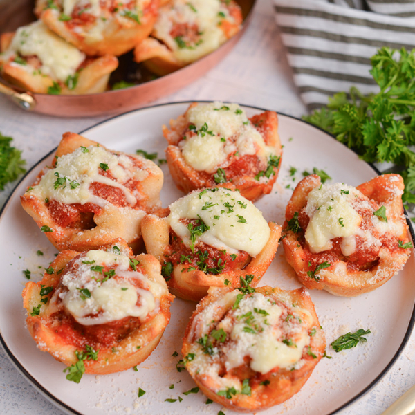 angled shot of plate of cheesy meatballs bombs