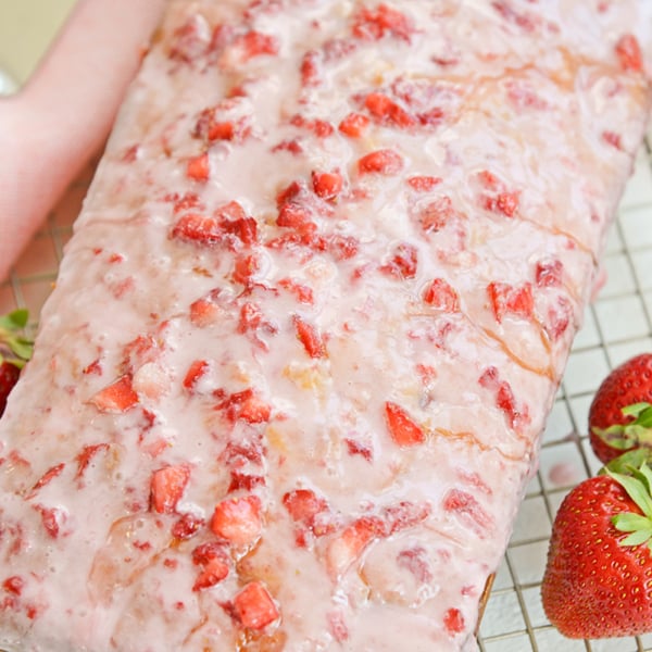 angle close up of pound cake with fresh strawberry icing