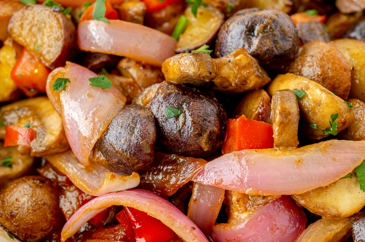 close up of cooked potatoes, peppers, onions and mushrooms