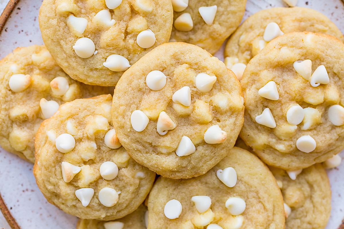 close up overhead shot of plate of white chocolate chip cookies