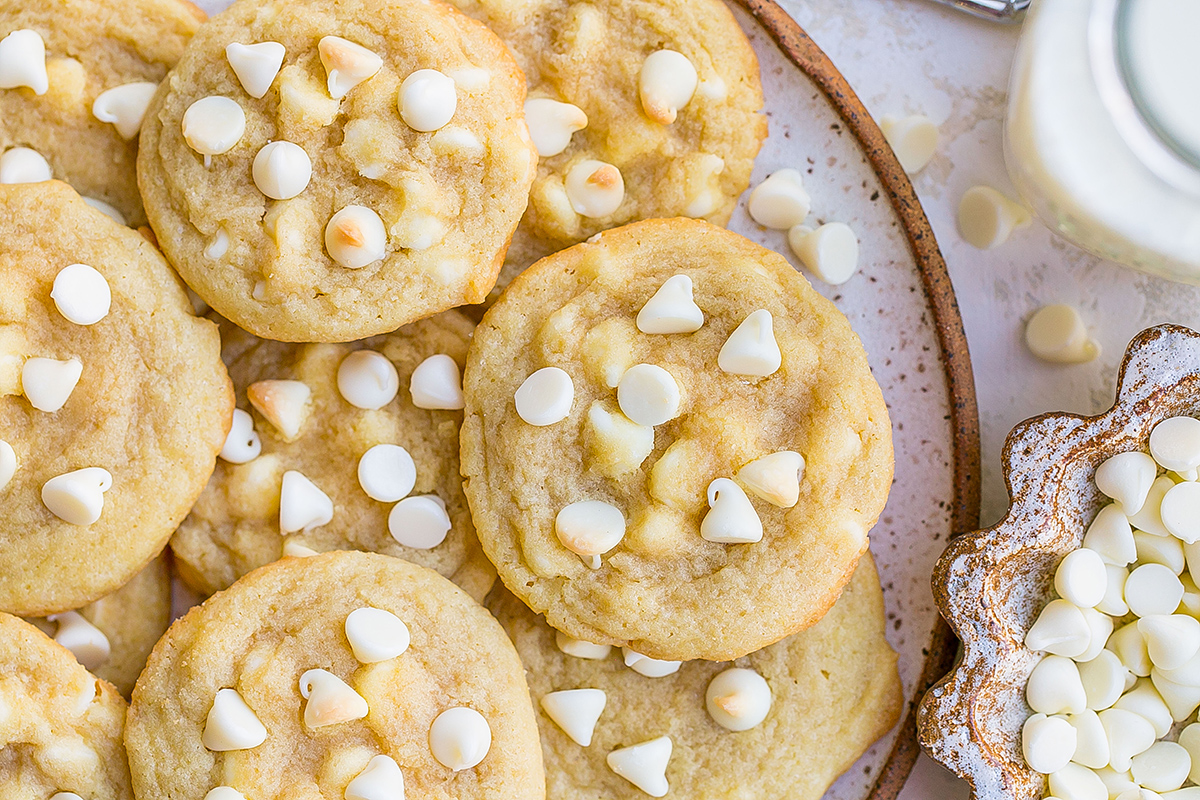 close up of white chocolate chip cookies on a plate