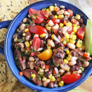 overhead of cowboy caviar with tortilla chips and lime