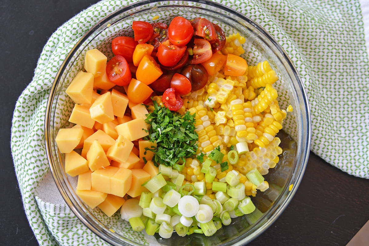 overhead shot of cold corn salad ingredients in bowl