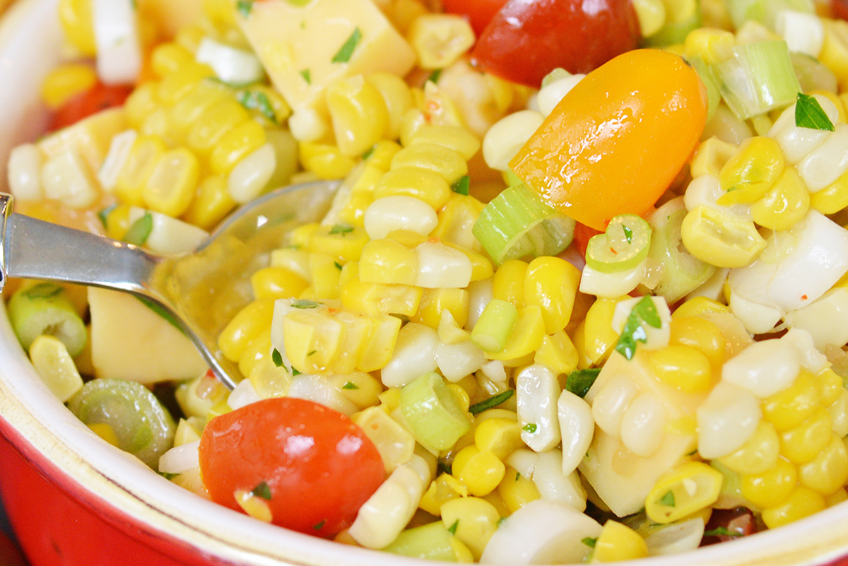 close up of spoon in corn salad recipe